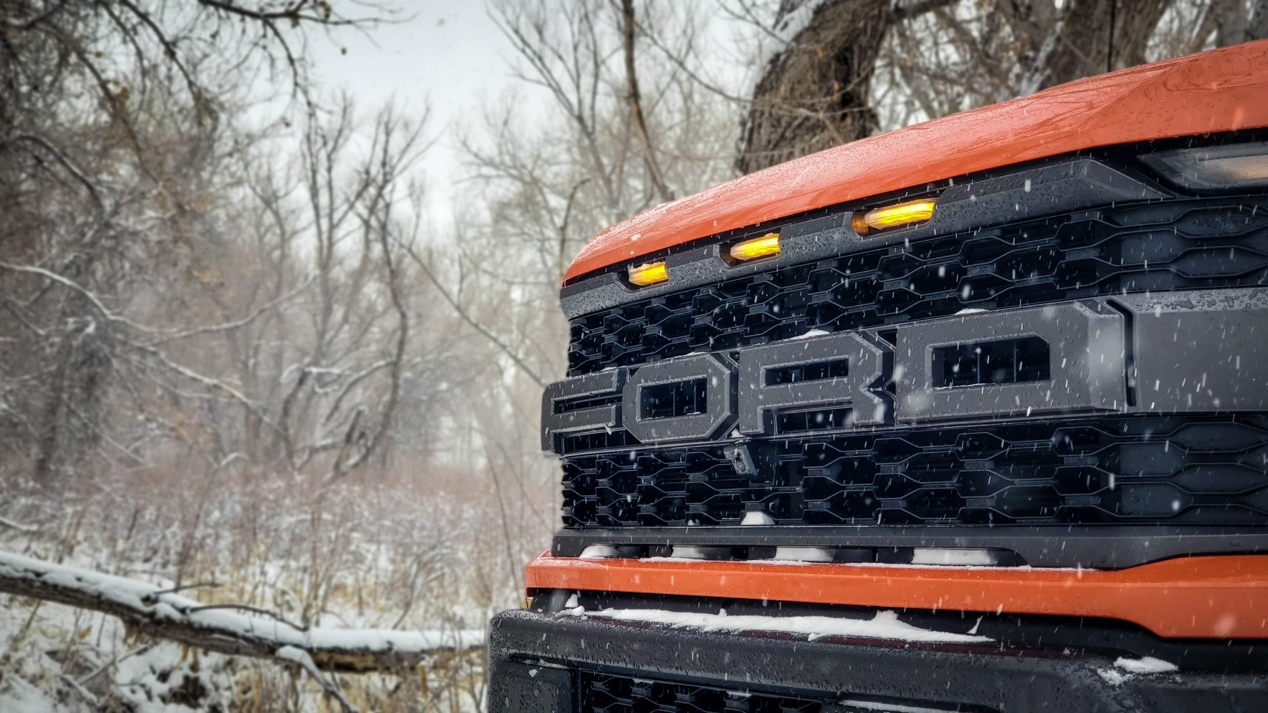 The front grille of the 2021 Ford Raptor in a snow storm
