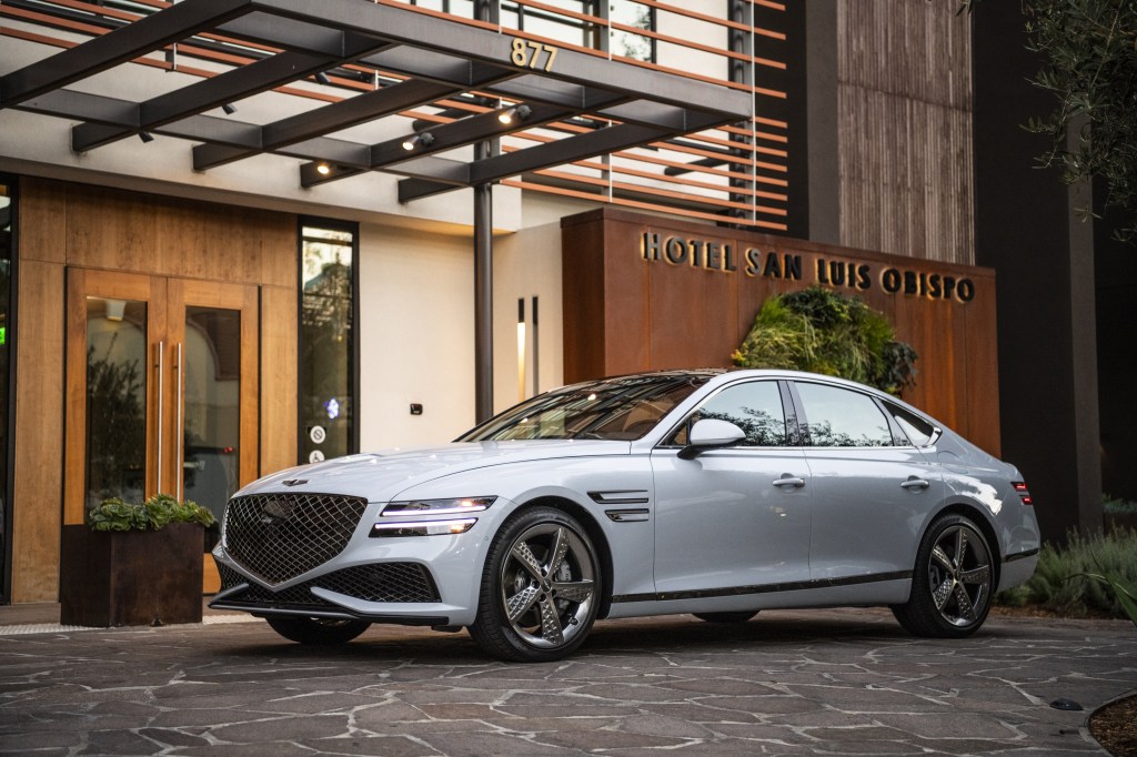 A white 2022 Genesis G80 parked in front of the Hotel San Luis Obispo