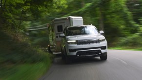 White 2022 Grand Wagoneer from Jeep towing a horse trailer