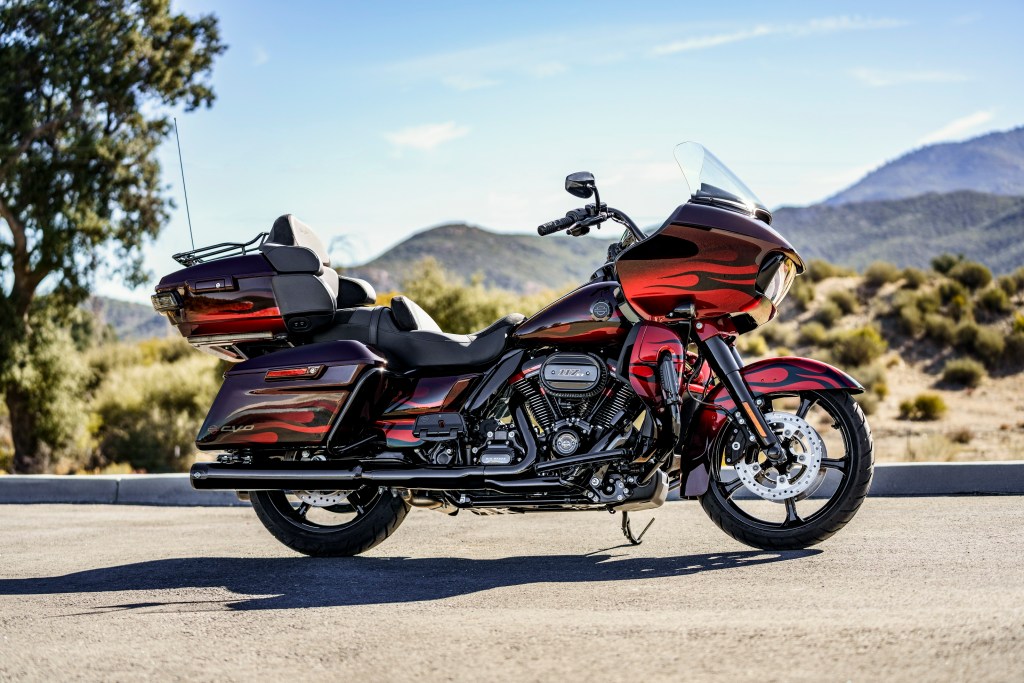 A red-and-black-flame 2022 Harley-Davidson CVO Road Glide Limited on a desert road