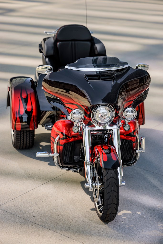 The front view of a red-and-black-flame 2022 Harley-Davidson CVO Tri Glide