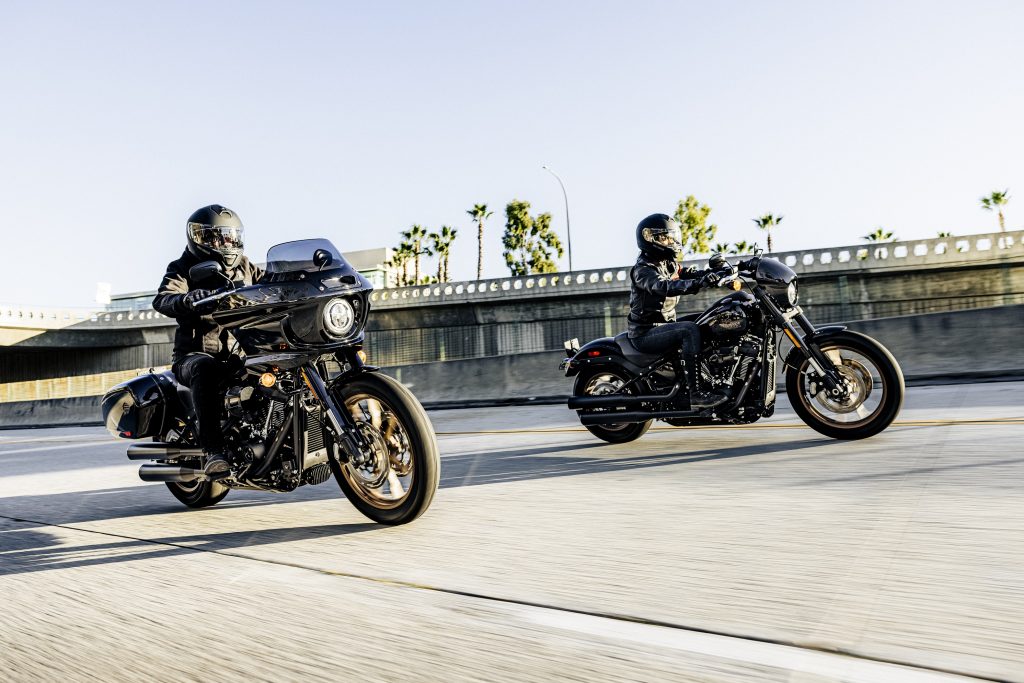Two riders on a black 2022 Harley-Davidson Low Rider ST and Low Rider S