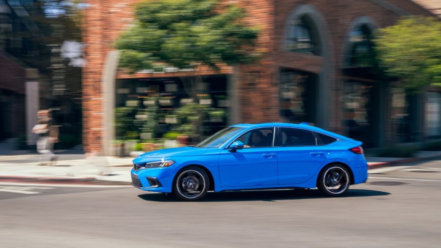 A blue 2022 Honda Civic hatchback with a manual transmission shot from the front 3/4