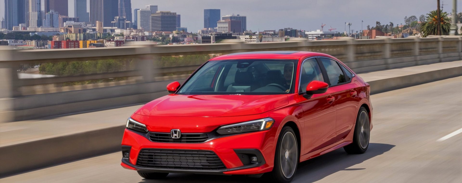 A red 2022 Honda Civic sedan shot from the front 3/4