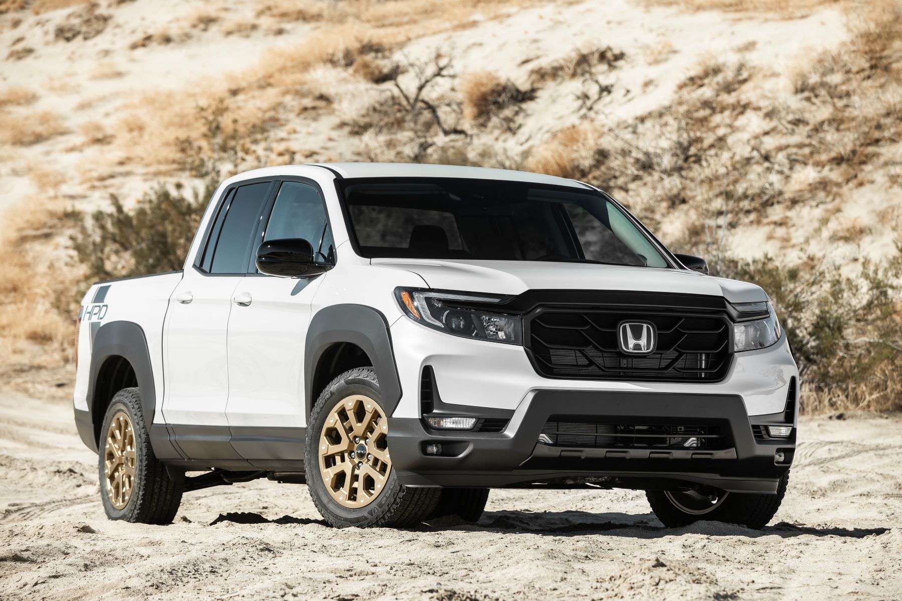 A 2022 Honda Ridgeline Sport unibody midsize pickup truck with the HPD Package parked in the middle of a desert