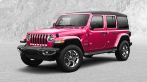 A pink 2022 Jeep Wrangler against a gray background.