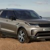 A gold 2022 Land Rover Discovery parked on sand.