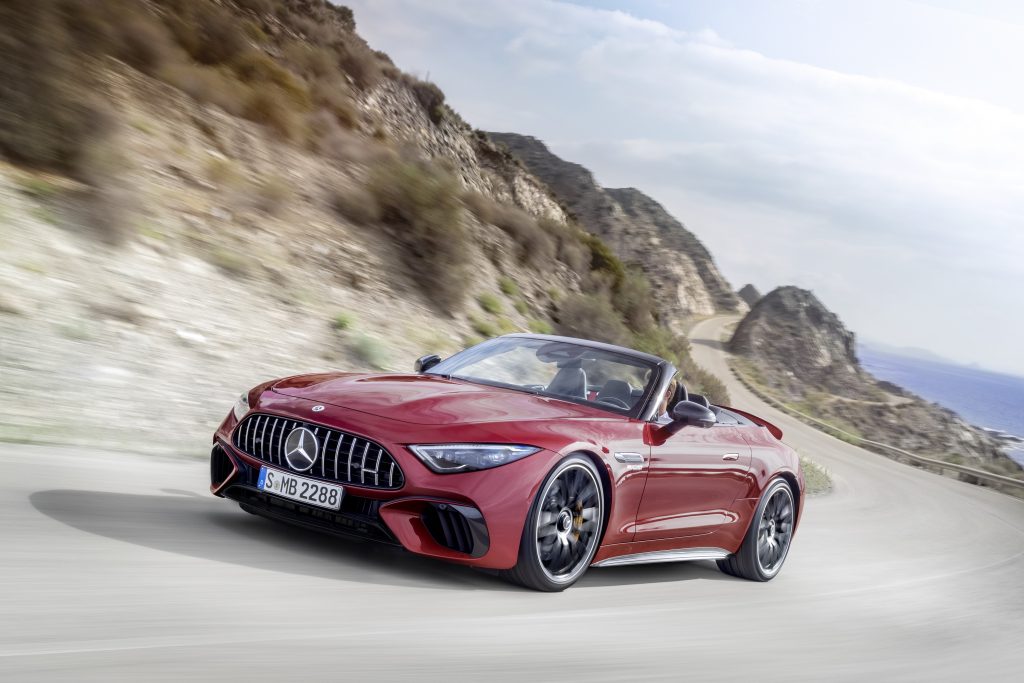 A red 2022 Mercedes-AMG SL 63 driving around a desert road