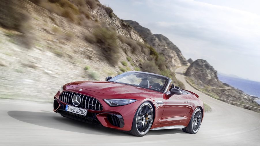 A red 2022 Mercedes-AMG SL 63 driving around a desert road
