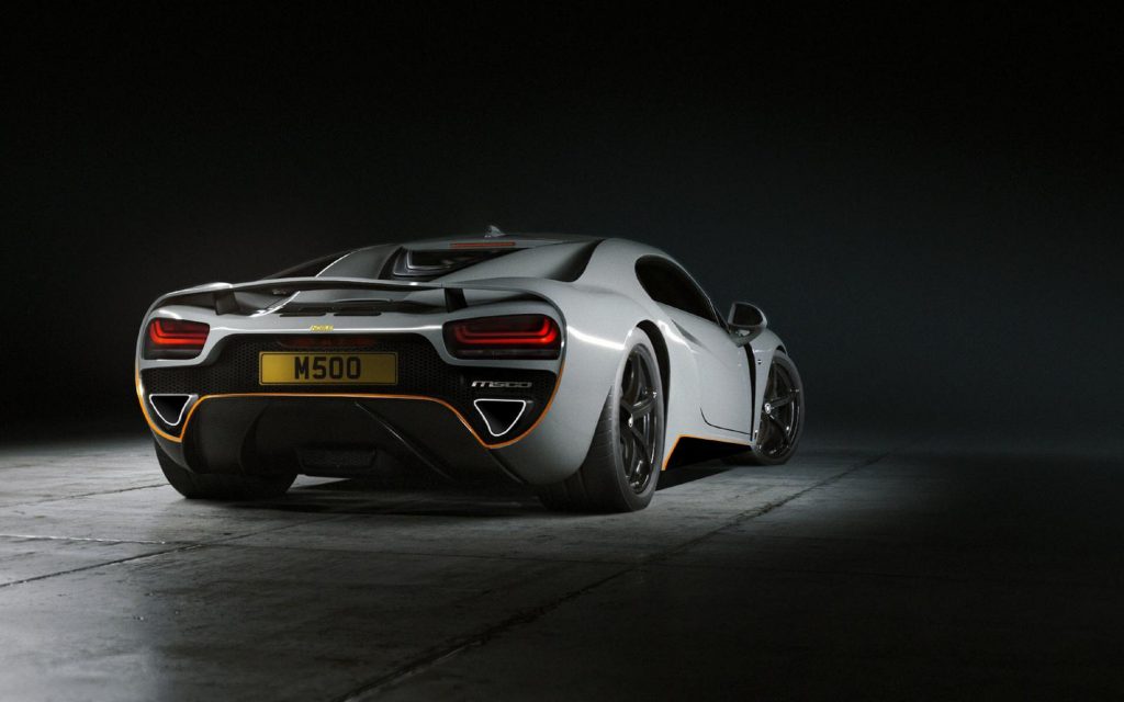 The rear 3/4 view of a gray 2022 Noble M500 in a black studio