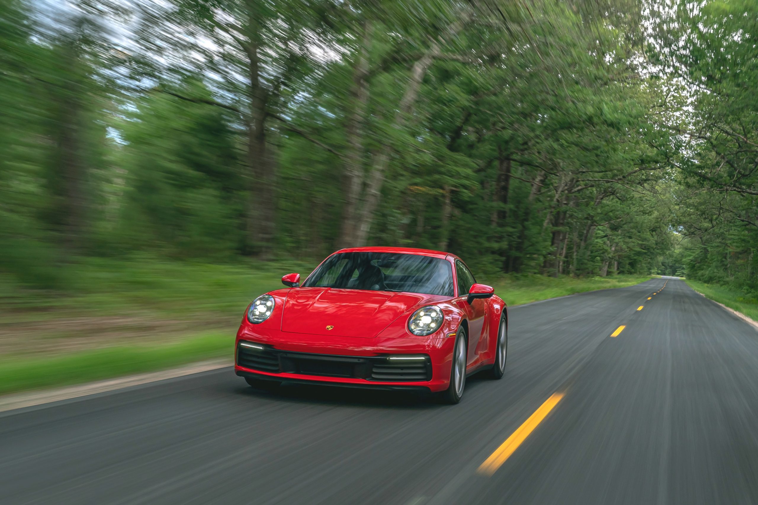 A Guards Red 2022 Porsche 911 Carrera shot from the front 3/4