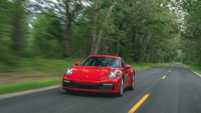 A Guards Red 2022 Porsche 911 Carrera shot from the front 3/4