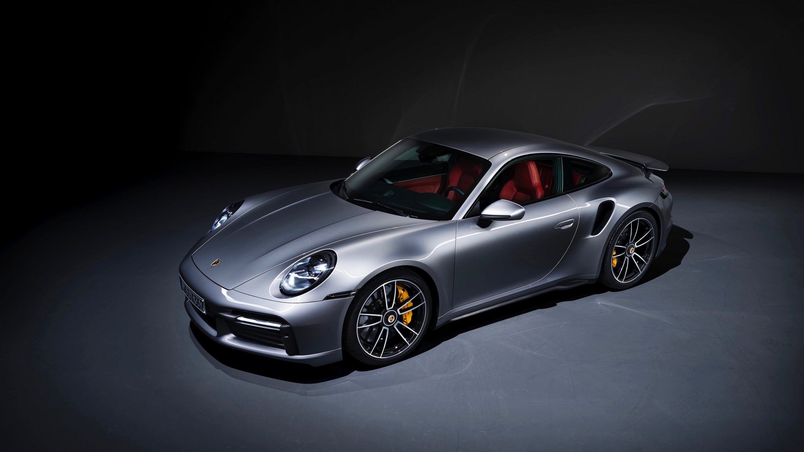 A silver Turbo S shot from the front 3/4 in a photo studio