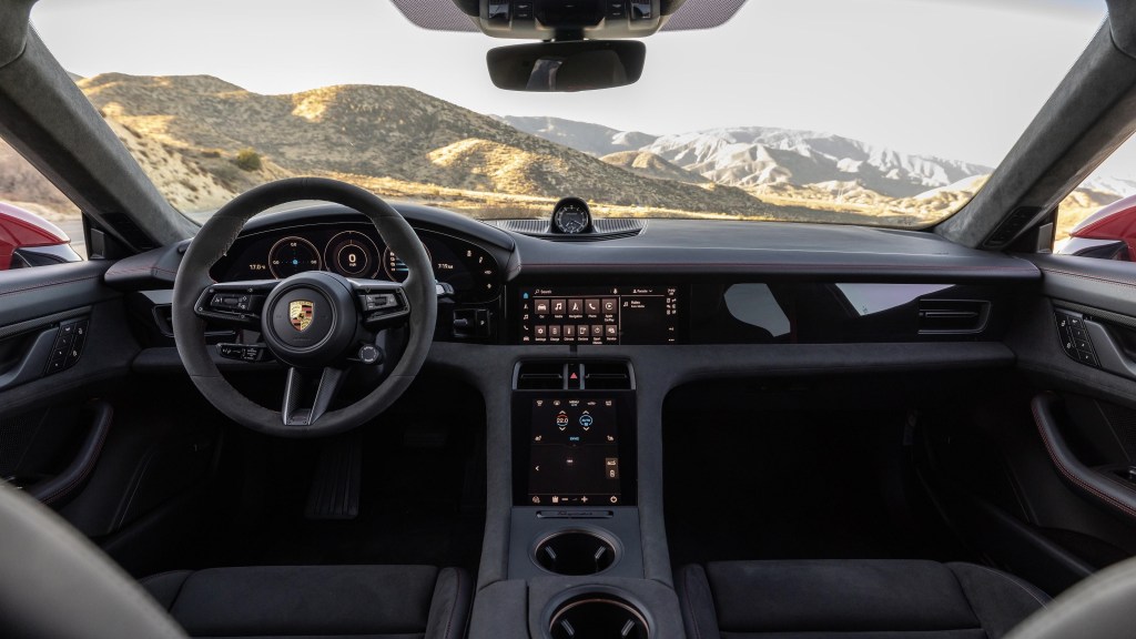 The 2022 Porsche Taycan GTS Sport Turismo's black dashboard and suede-upholstered center console