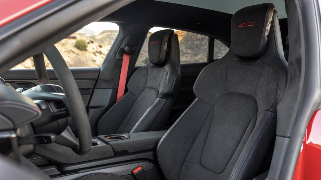 A red 2022 Porsche Taycan GTS Sport Turismo's black leather-and-suede-upholstered front seats