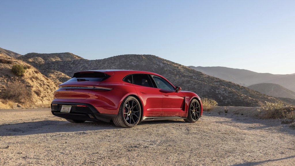 The rear 3/4 view of a red 2022 Porsche Taycan GTS Sport Turismo parked in the LA canyons
