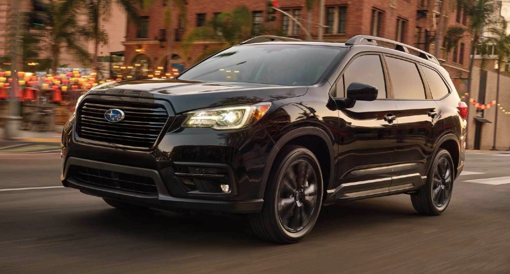 A black 2022 Subaru Ascent is driving down the road. 