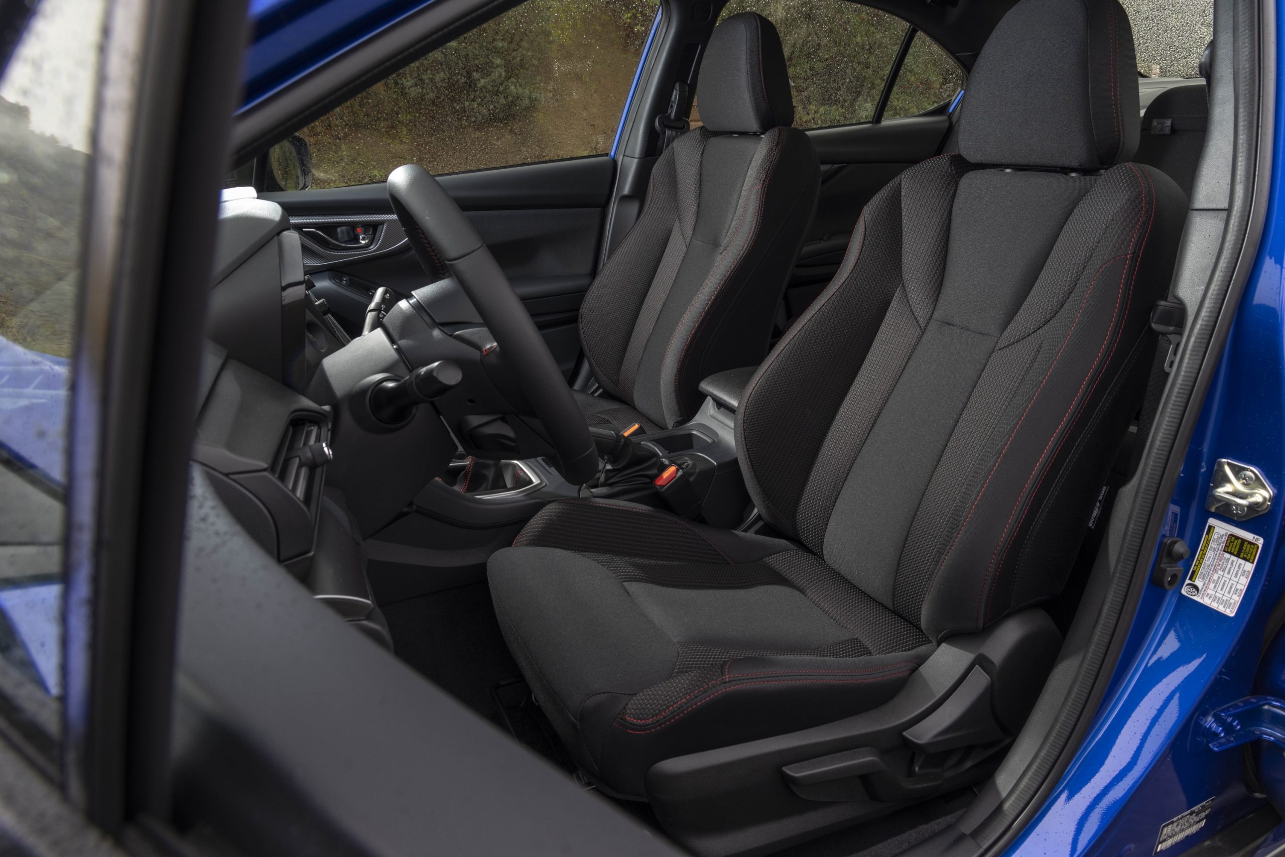 The black cloth interior of the new Subaru WRX with red stitching accents