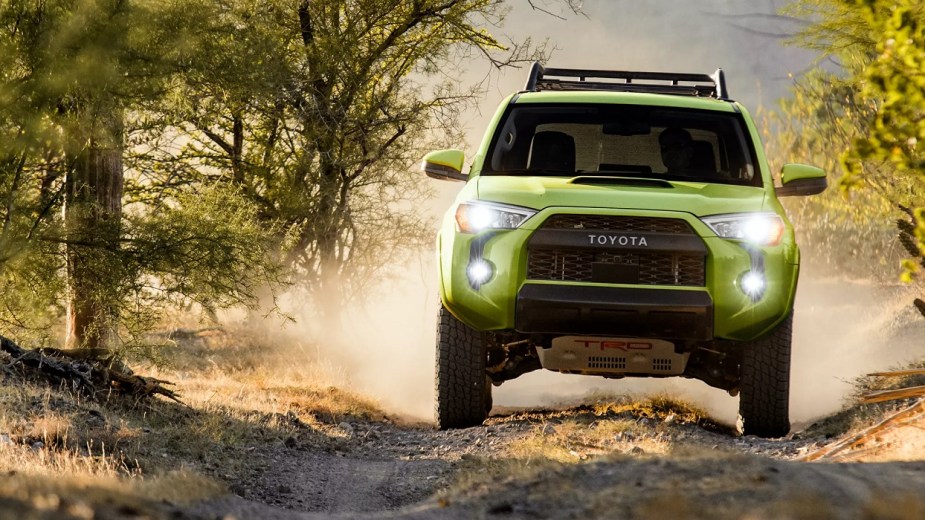 A lime green 2022 Toyota 4Runner TRD Pro driving through the woods.