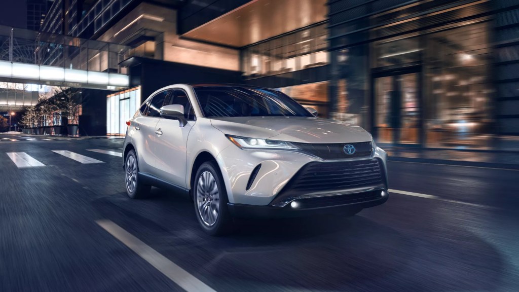 A white 2021 Toyota Venza vs. 2022 Ford Edge, price, features, fuel economy, and more in this midsize SUV battle.
