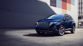A dark blue 2022 Hyundai Tucson Hybrid in the city.