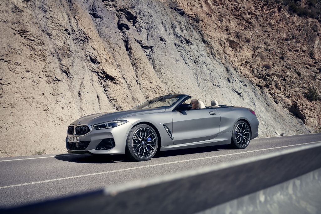 A silver 2023 BMW M850i xDrive Convertible on a mountain road