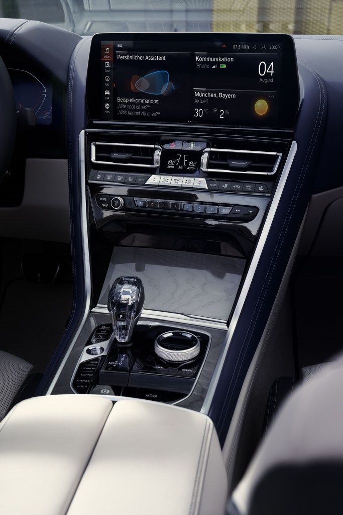 The center touchscreen, crystal shifter, and center console of a 2023 BMW M850i xDrive Convertible
