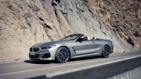 A silver 2023 BMW M850i xDrive Convertible on a mountain road
