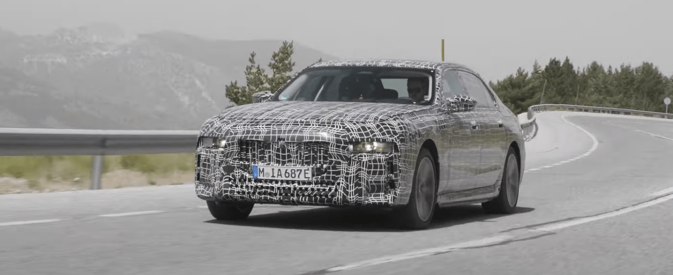2023 BMW i7, the next-generation all-electric 7 Series, driving on a mountain road