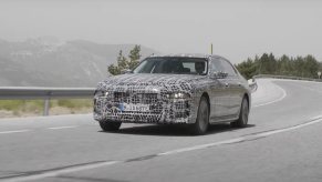 2023 BMW i7, the next-generation all-electric 7 Series, driving on a mountain road