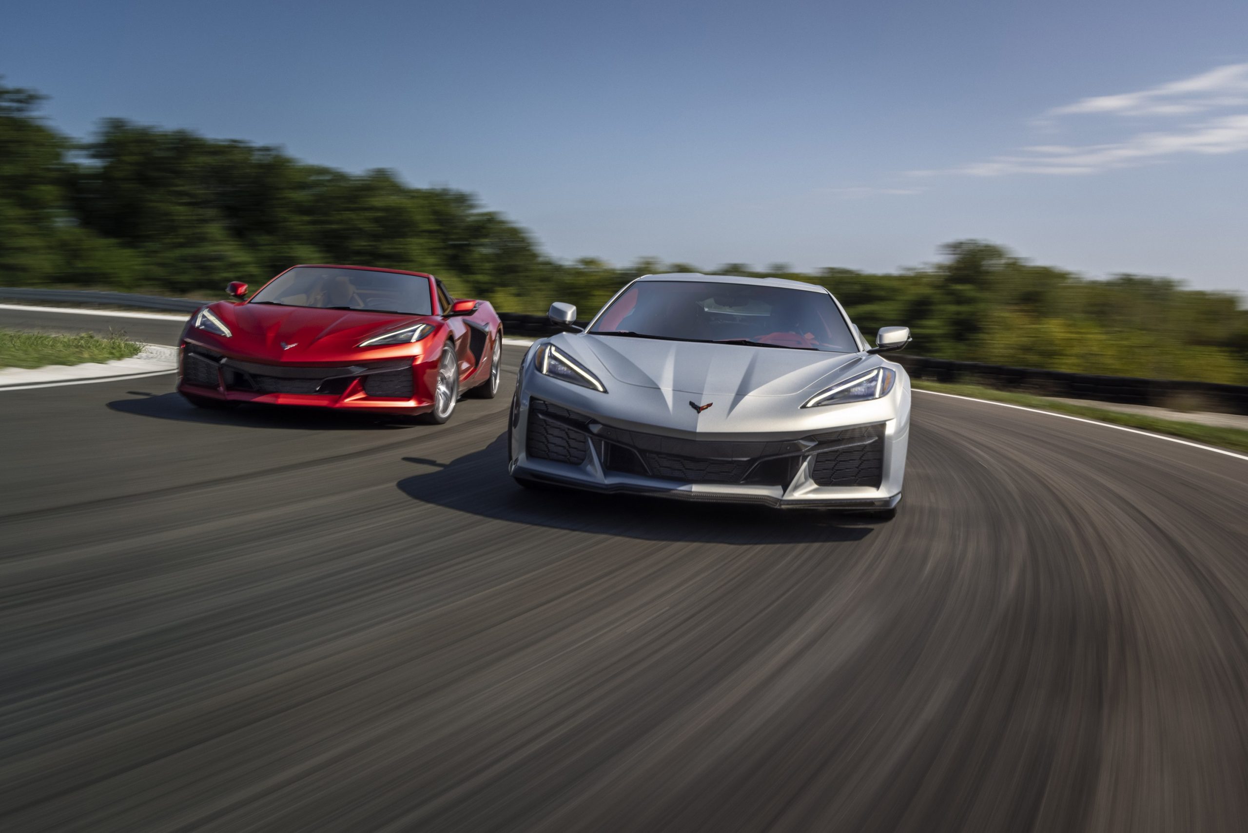 A pair of Chevrolet Corvette Z06 models in red and silver on a race track