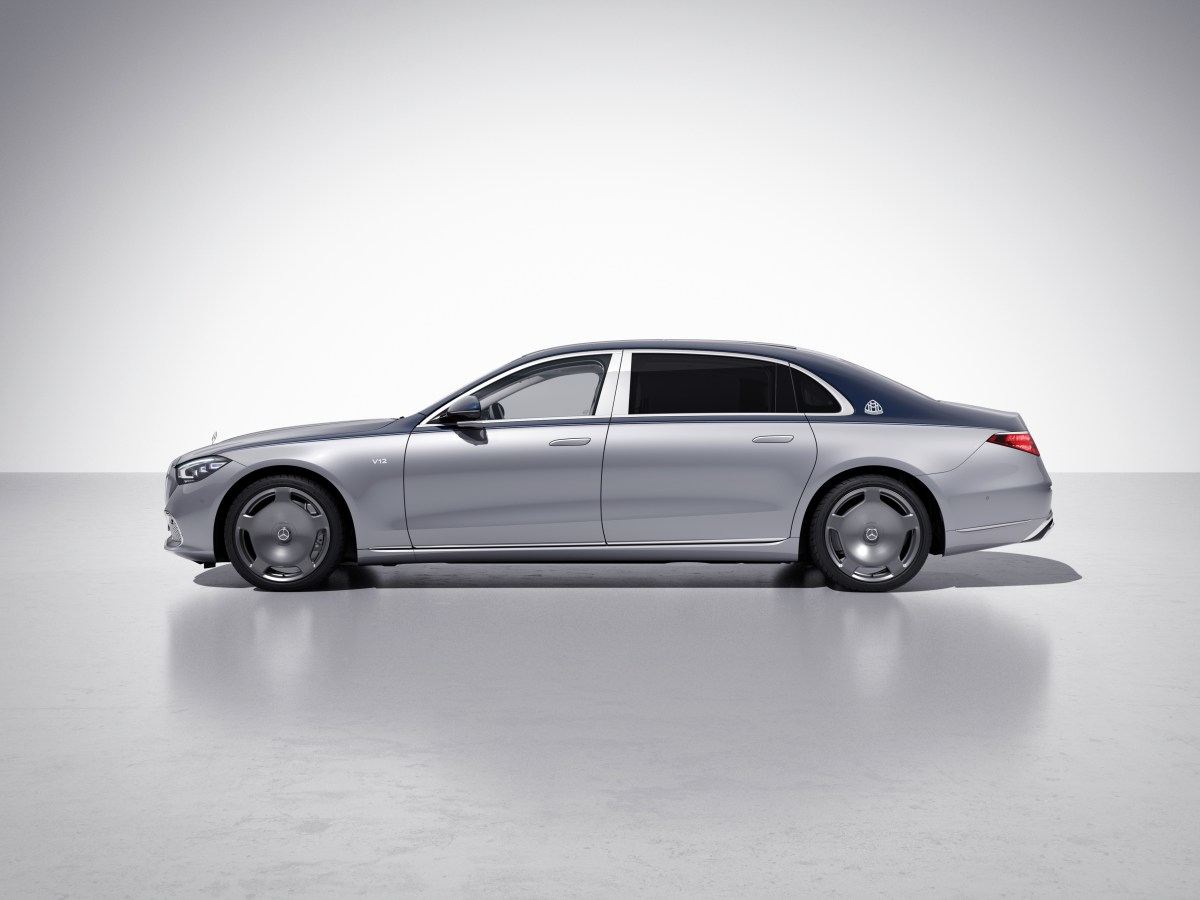 A profile view of a silver and blue Mercedes-Maybach S680 in front of a white background