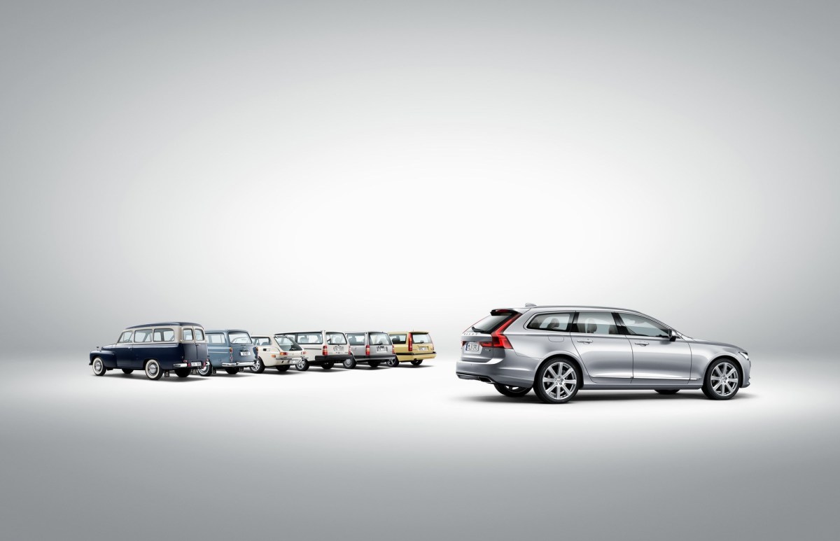 A profile view of a silver Volvo V90 T6 with several older Volvo wagon models.
