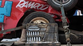 A car tool kit next to a red race car