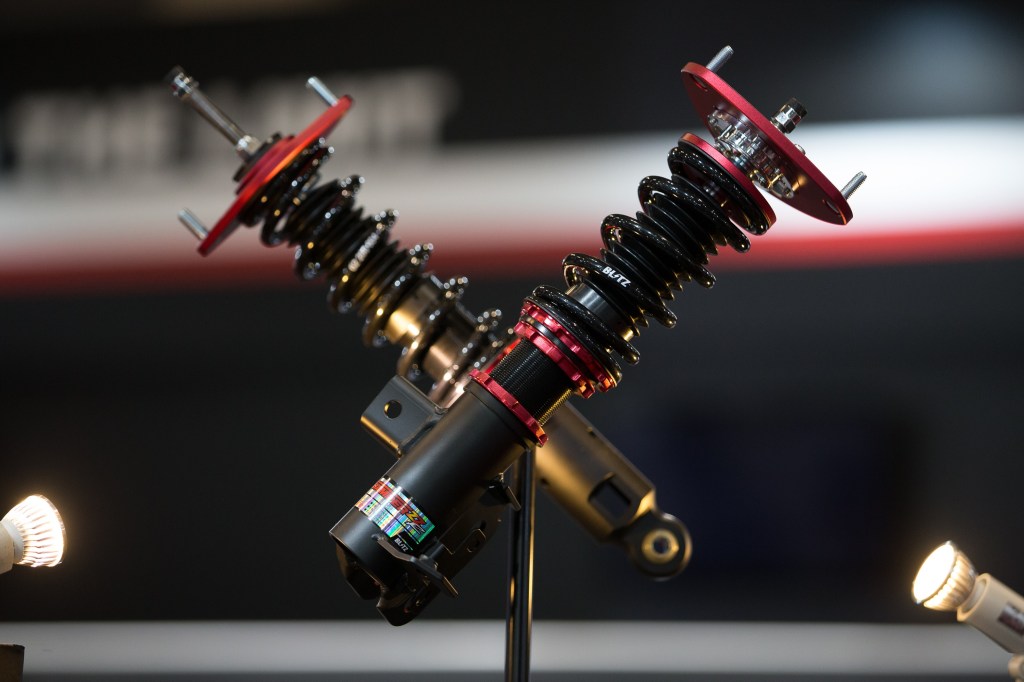 A set of black-red-and-gold Blitz coilovers at the 2017 Tokyo Auto Salon