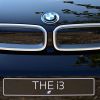 The front end of a blue BMW i3 with the grille and logo displayed and a plate that reads 'THE i3.'