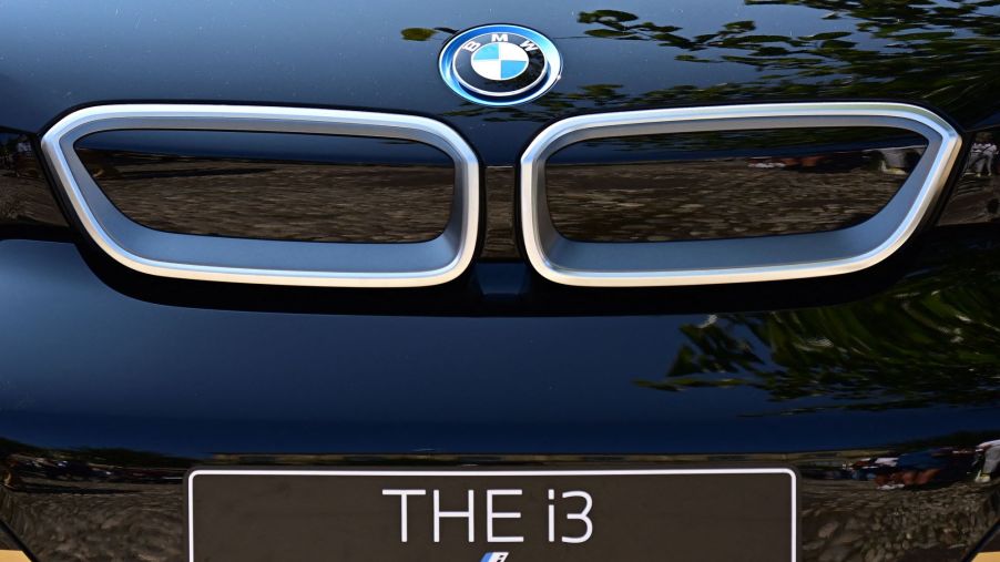 The front end of a blue BMW i3 with the grille and logo displayed and a plate that reads 'THE i3.'