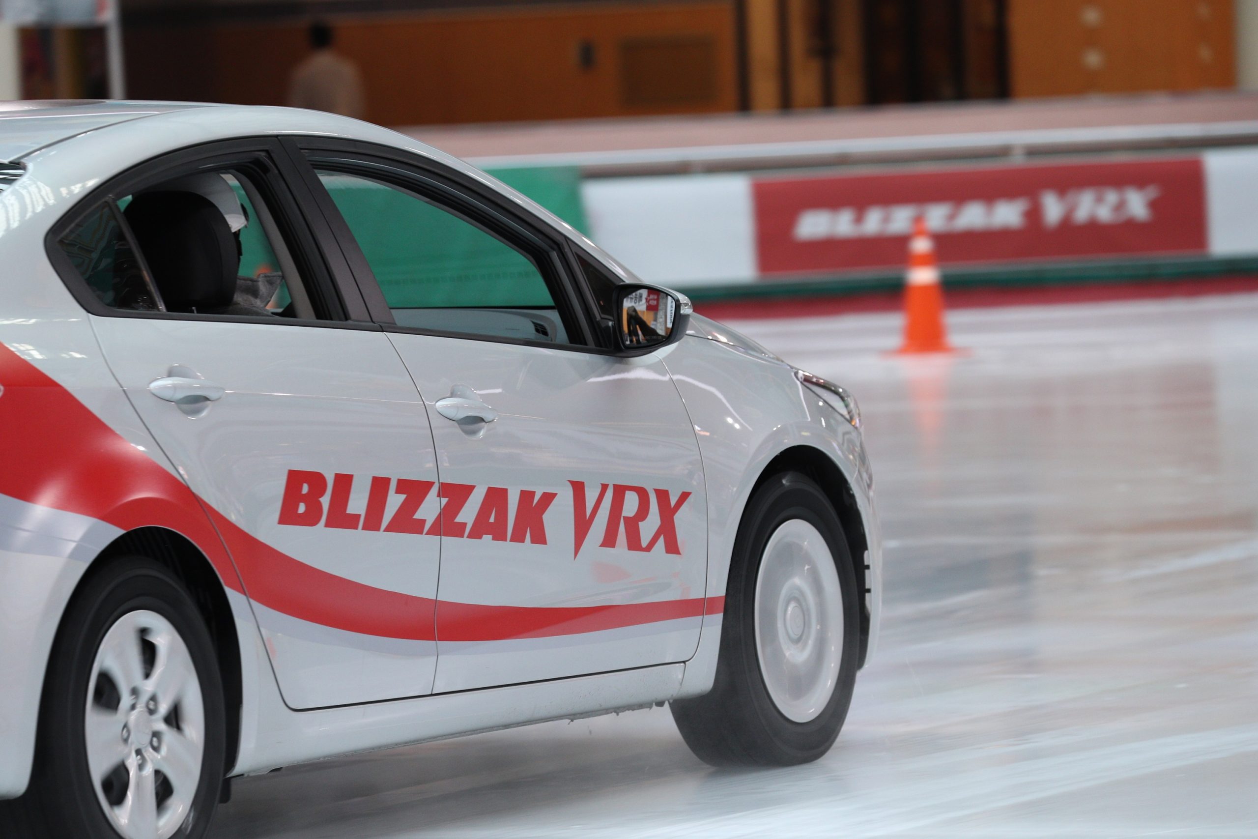 A car drives on ice with Bridgestone Blizzak tires