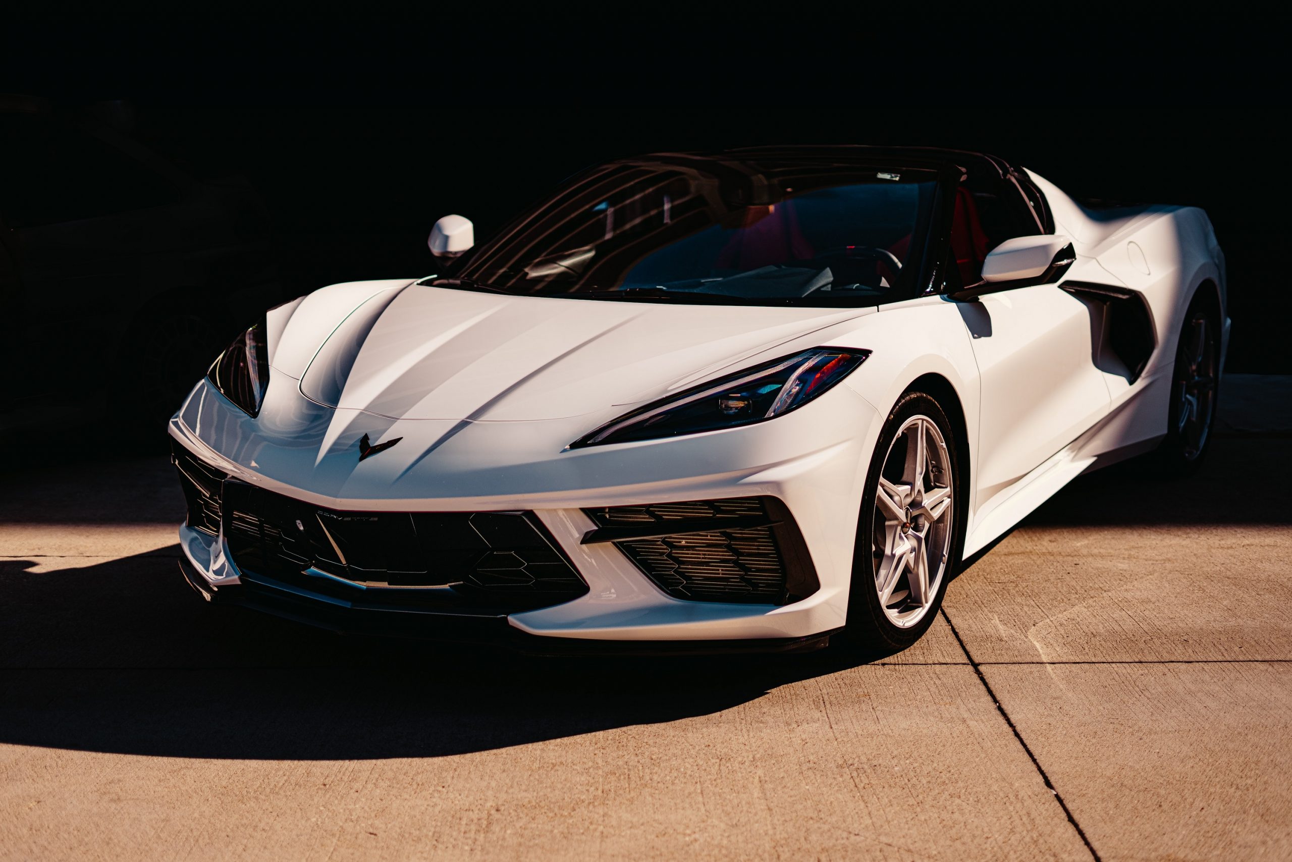A white C8 Chevrolet Corvette shot in the sun from the front 3/4