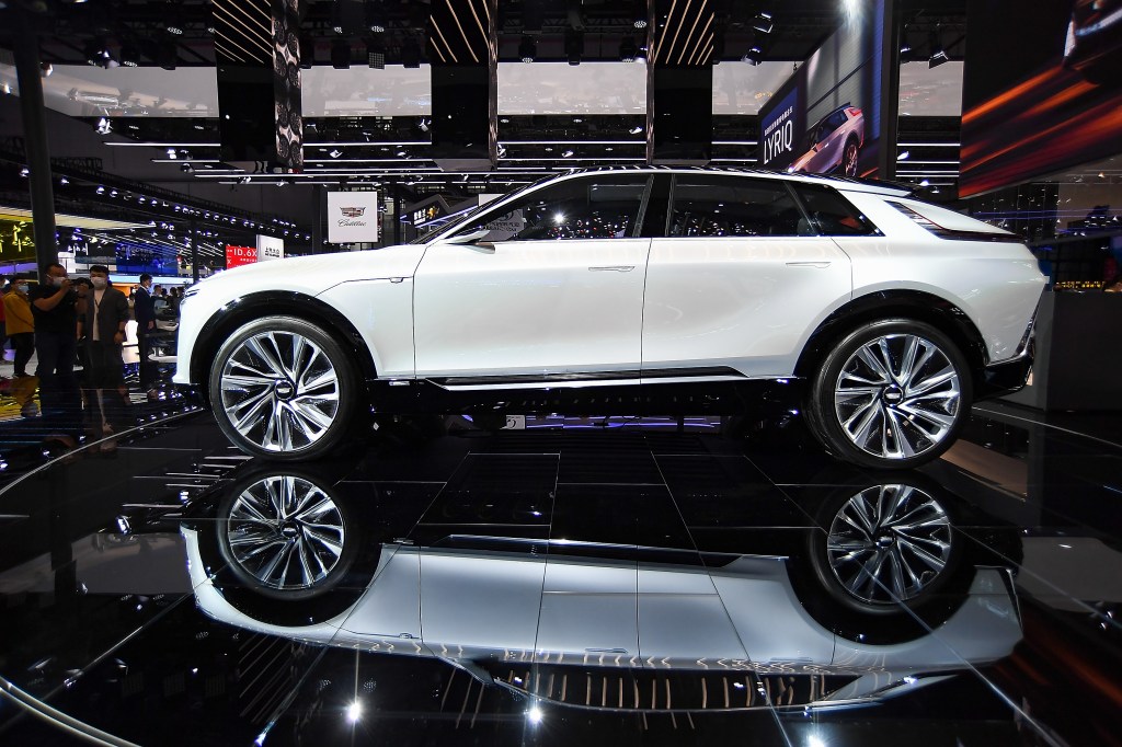 A Cadillac Lyriq concept electric vehicle is on display at an auto show.