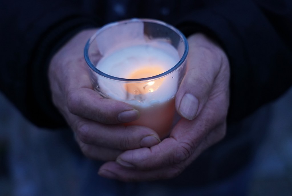 someone holding a candle in their hands