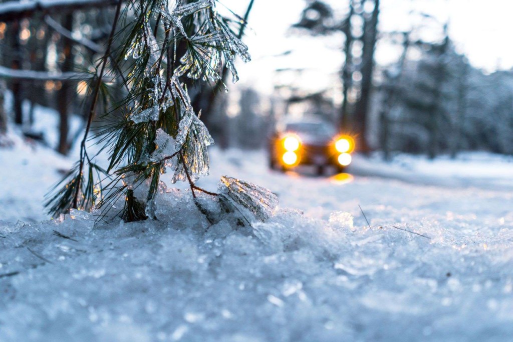 Car driving on an icy road, highlighting article about how to start a car in cold weather
