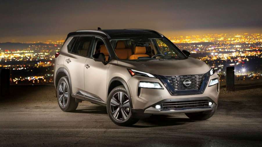 Champagne Silver Metallic 2022 Nissan Rogue with a city skyline in the background