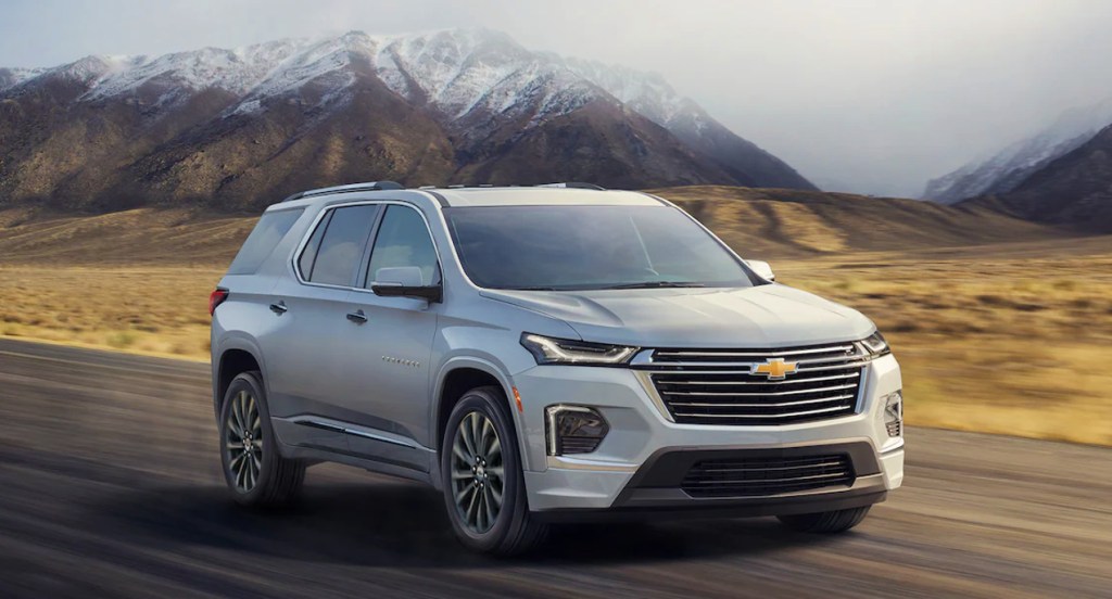 A gray 2022 Chevy Traverse is driving down the road. 