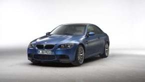 A dark blue E92 BMW M3 sports car shot from the front 3/4 in a photo booth