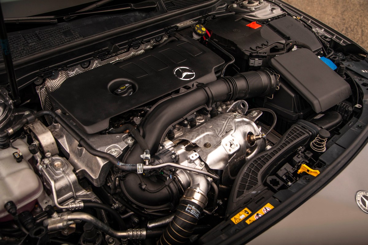An overhead view of the four-cylinder turbocharged engine under the hood of a Mercedes-Benz A220