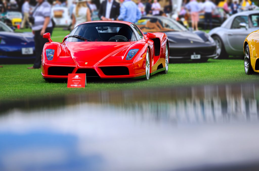A red Ferrari Enzo at a fancy car show. 