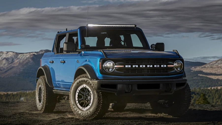 A blue Ford Bronco Badlands is parked outdoors.