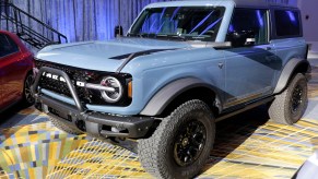 A blue Ford Bronco is on display.