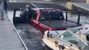 Ford F-150 attempting to launch a boat from the boat ramp.